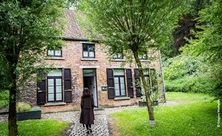 Un femme devant le Maison Van Gogh