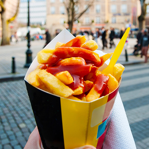 a paper cone of belgian fries