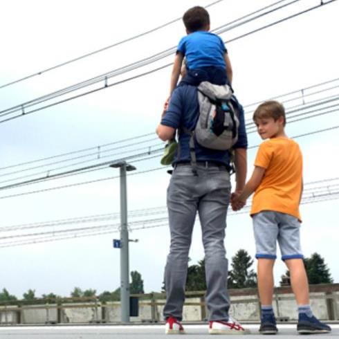 Un papa avec ses 2 fils sur le quai.